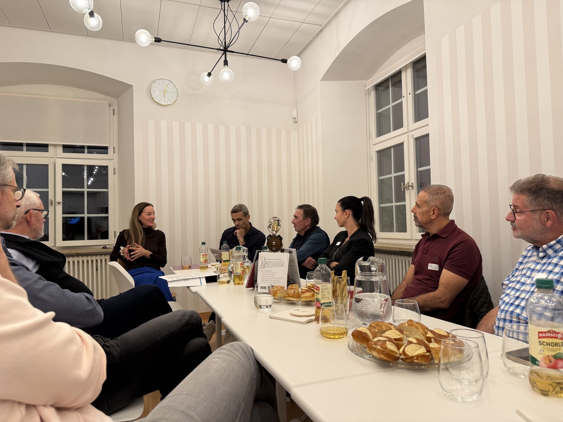 Tabea Studer, Leiterin HR der Gemeindeverwaltung Arlesheim, spricht am iPunkt-Stammtisch mit den Teilnehmenden, die gemeinsam an einem langen Tisch sitzen.